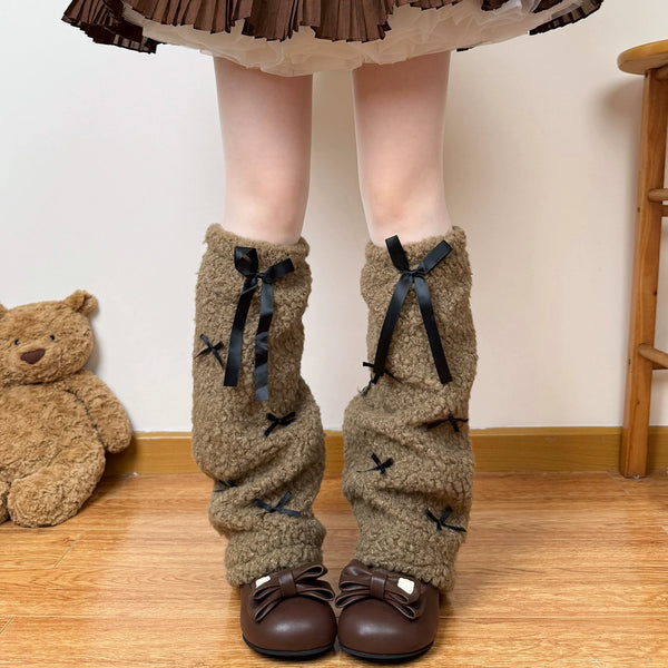 White plush stacked leg warmers decorated with black ribbon bows