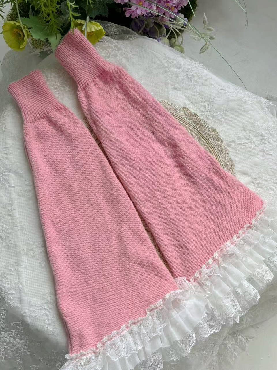 Pair of pink stacked leg warmers with white lace ruffle trim