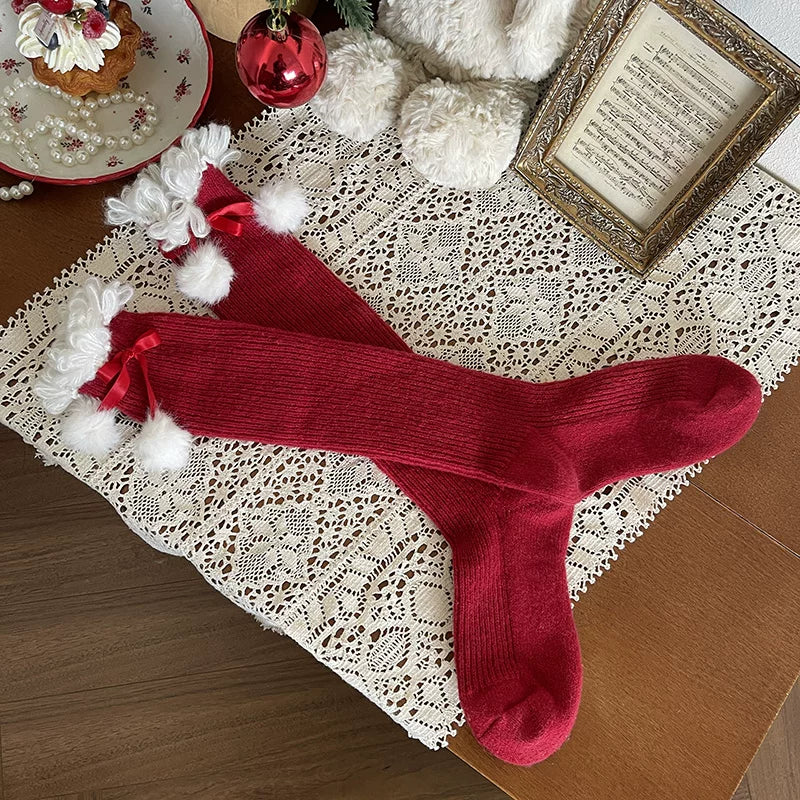Bright red scrunch socks with white trim and pom-pom bows