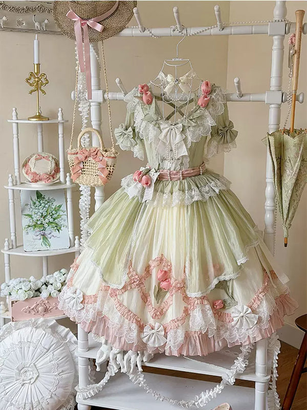 Green and pink floral Lolita dress on a display form, with lace trim and layered ruffles.
