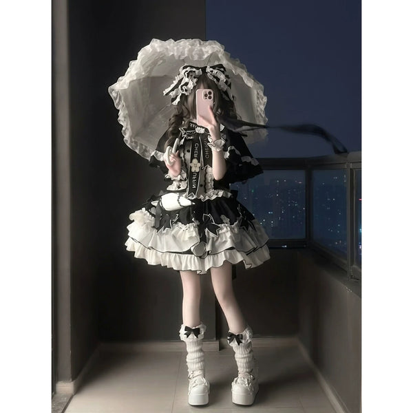Black-and-white JSK dress set with cape, train, ruffles, and headpiece
