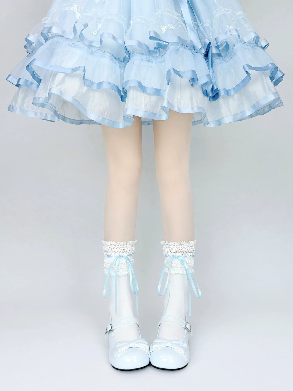 Lace-trimmed white mid-calf socks with blue ribbon ties