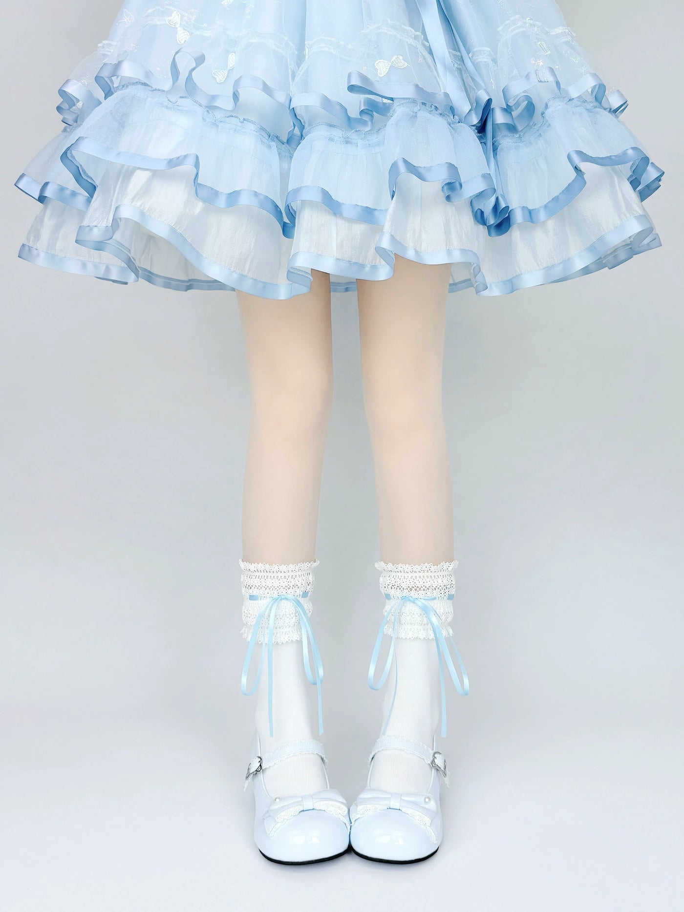 Lace-trimmed white mid-calf socks with blue ribbon ties