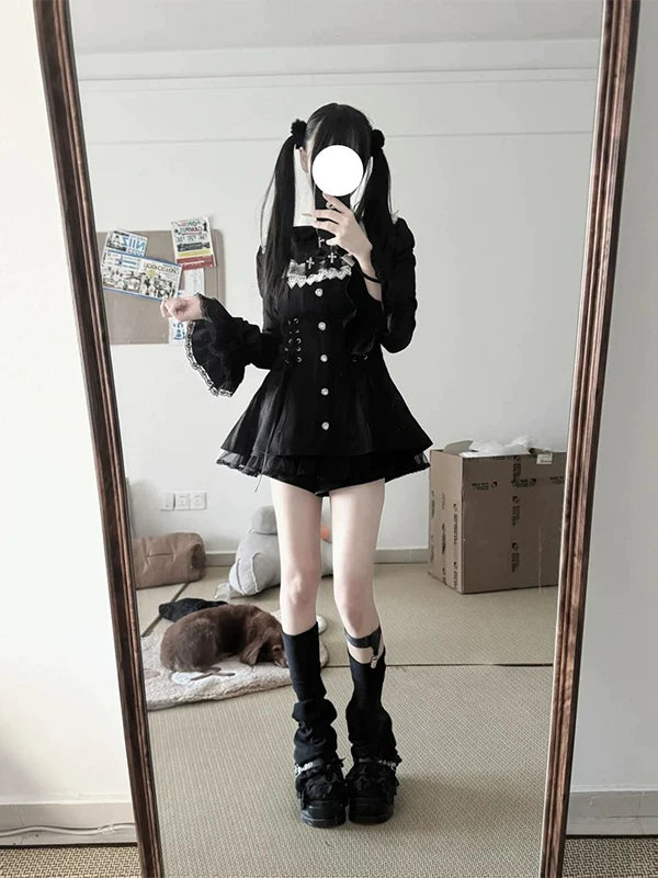 Mirror photographs of a black one-piece dress and shorts set with a lace bib and flared skirt.