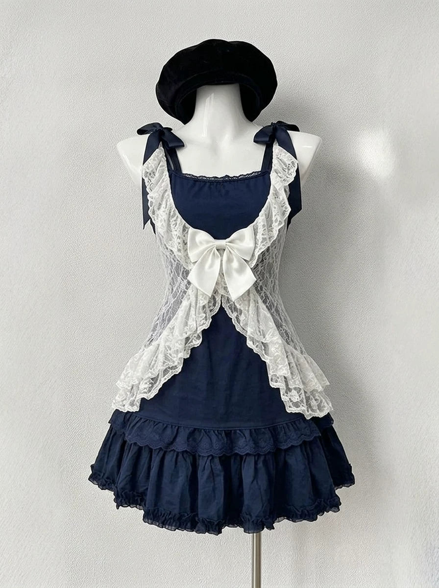 Navy and white sweet lolita 3-piece coord set with lace cardigan, bow camisole top, and tiered ruffled mini skirt on a mannequin