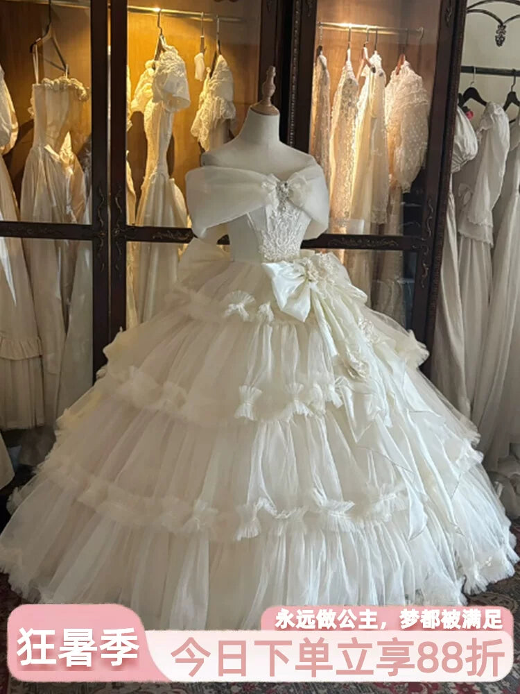 Flora Muse champagne Lolita bridal ball gown with off-shoulder neckline and tiered skirt