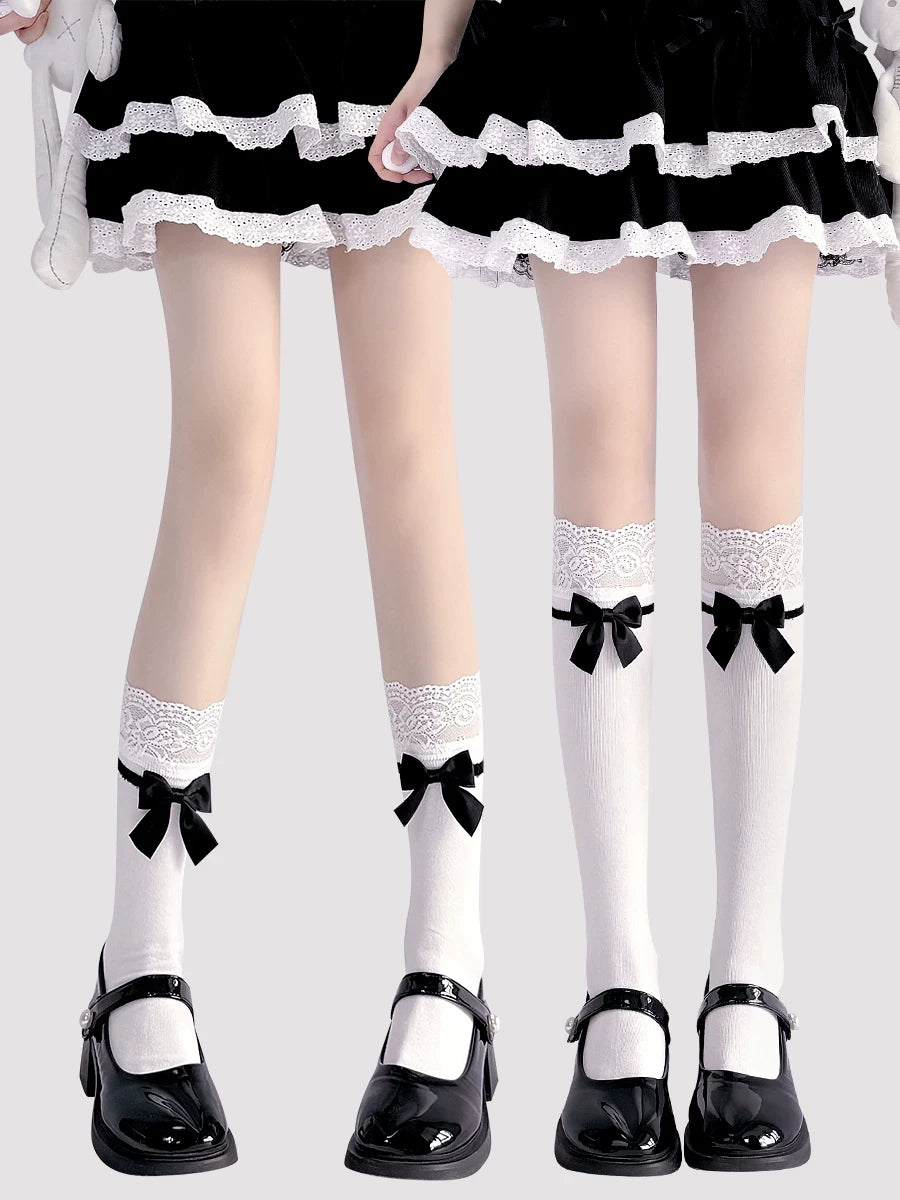 White socks with lace bands and black bows styled with a black skirt and patent shoes