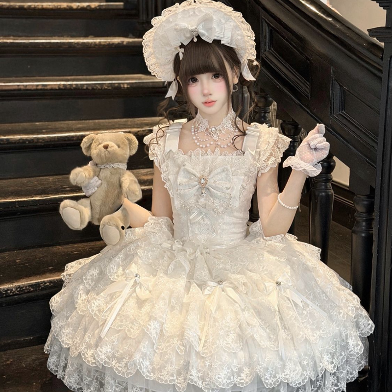 White Sweet Lolita wedding JSK with tiered ruffles and bow embellishments displayed on mannequin