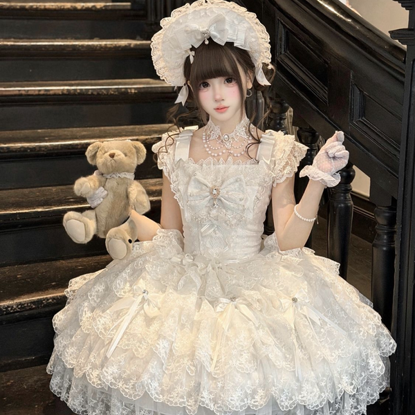 White Sweet Lolita wedding JSK with tiered ruffles and bow embellishments displayed on mannequin