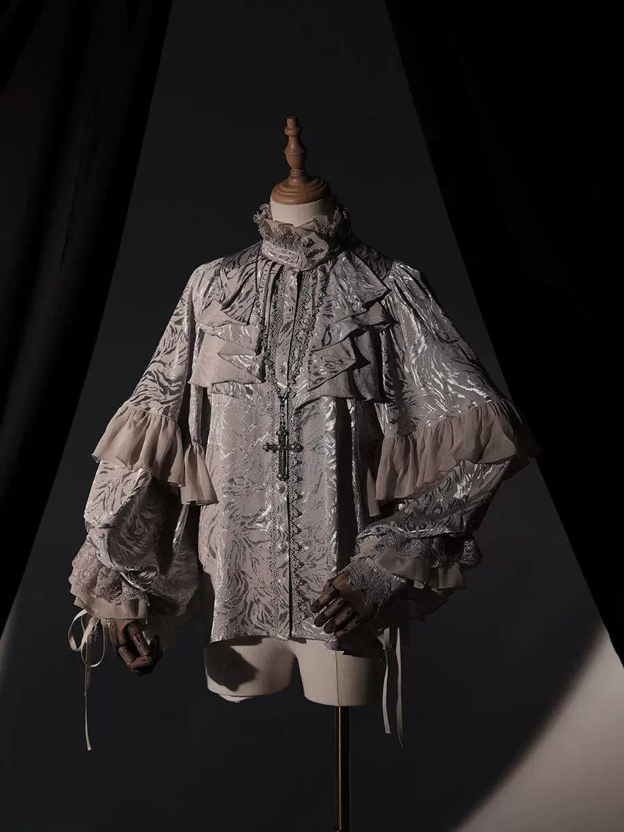Ruffled batwing blouse in dark and red colourways displayed on mannequins.