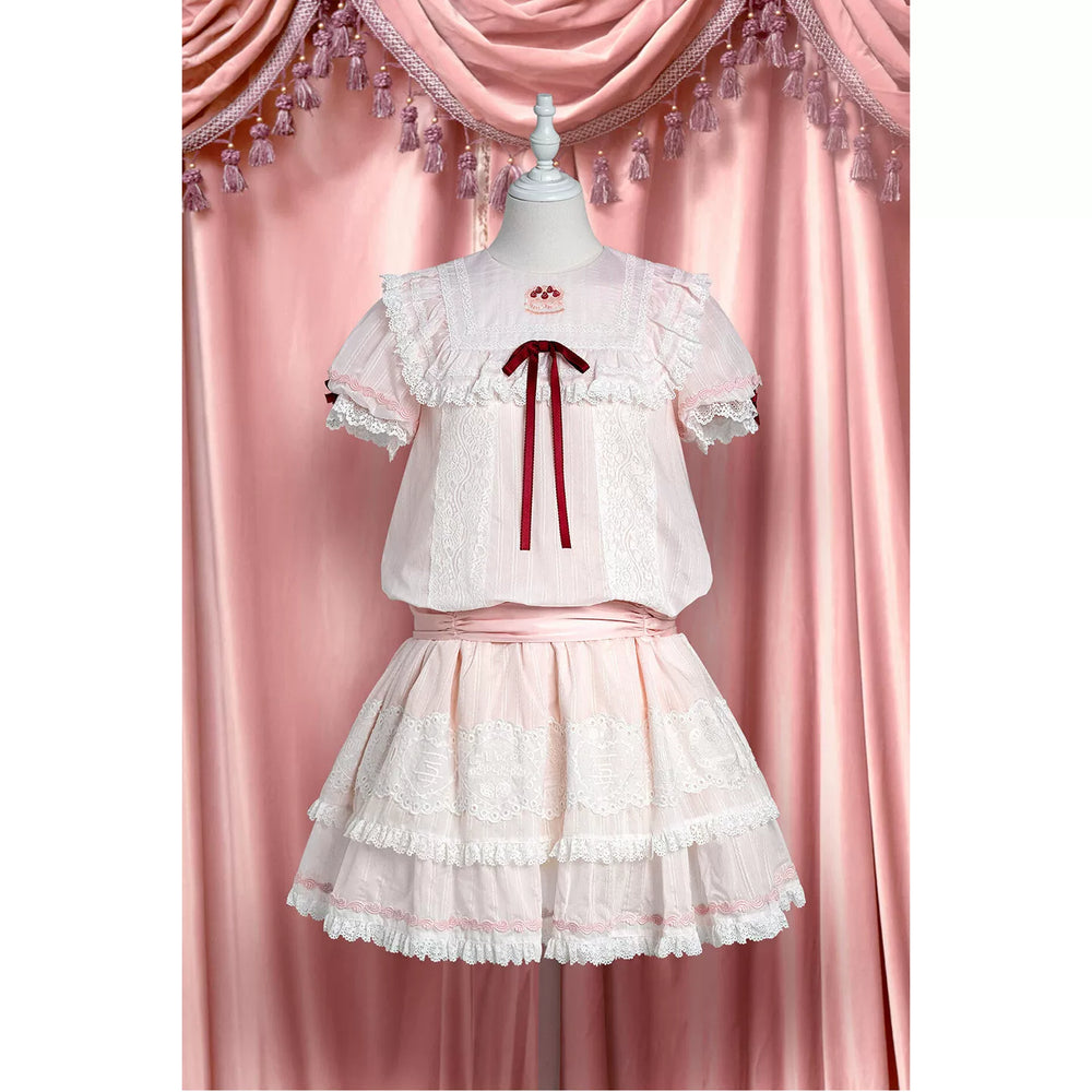 Pink-and-white low-waist one-piece dress with strawberry-themed panels and layered lace tiers.