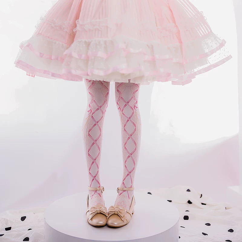 Pink and blue ribbon-lattice tights styled with a pastel dress and bow shoes