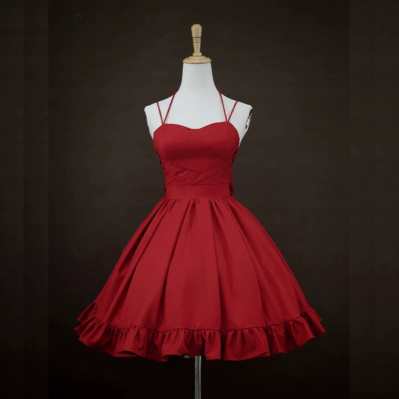 Red JSK dress on a mannequin showing thin straps, crossover front and gathered skirt.