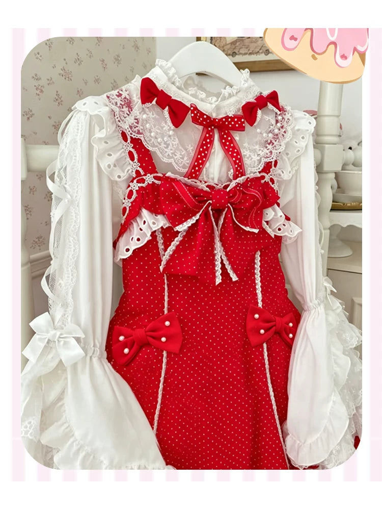 Pink-and-white polka-dot JSK with bows and layered ruffles displayed on a hanger.