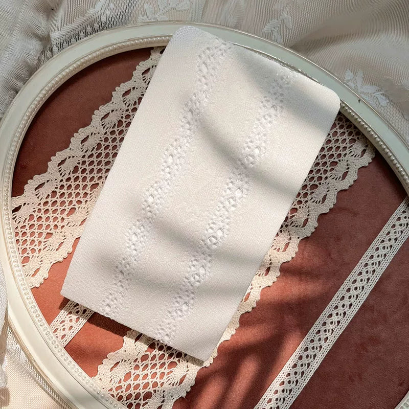 White lace tights with vertical lace panels styled beneath a ruffled dress.