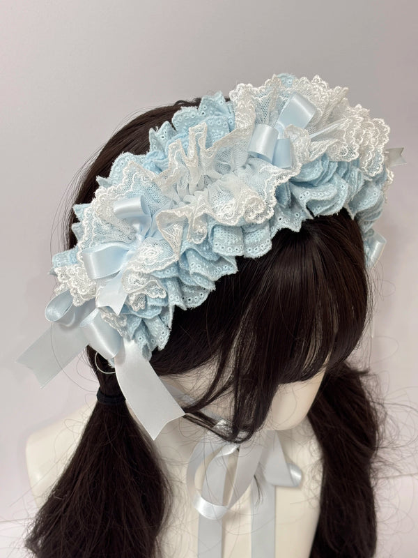 Blue and white lace hairband with layered bows and long ribbons shown on a mannequin.