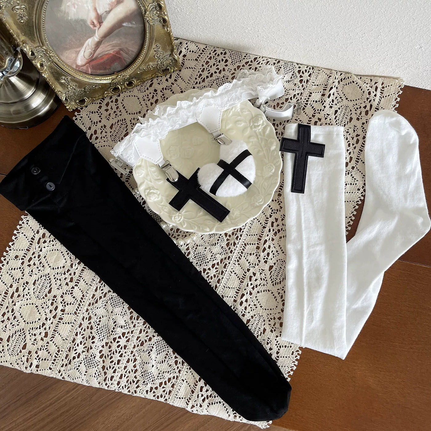 Black and white gothic sock layering combination with cross motifs on a model