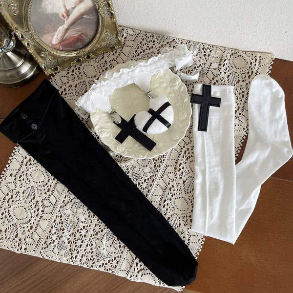 Black and white gothic sock layering combination with cross motifs on a model