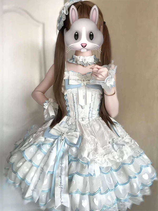Creamy blue-and-white ballet-inspired jumper skirt with layered ruffles and bows on a model.