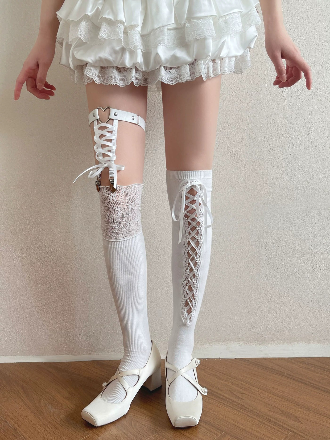 Sock Noble white over-the-knee socks with ribbon-laced panels and lace trim styled on a model