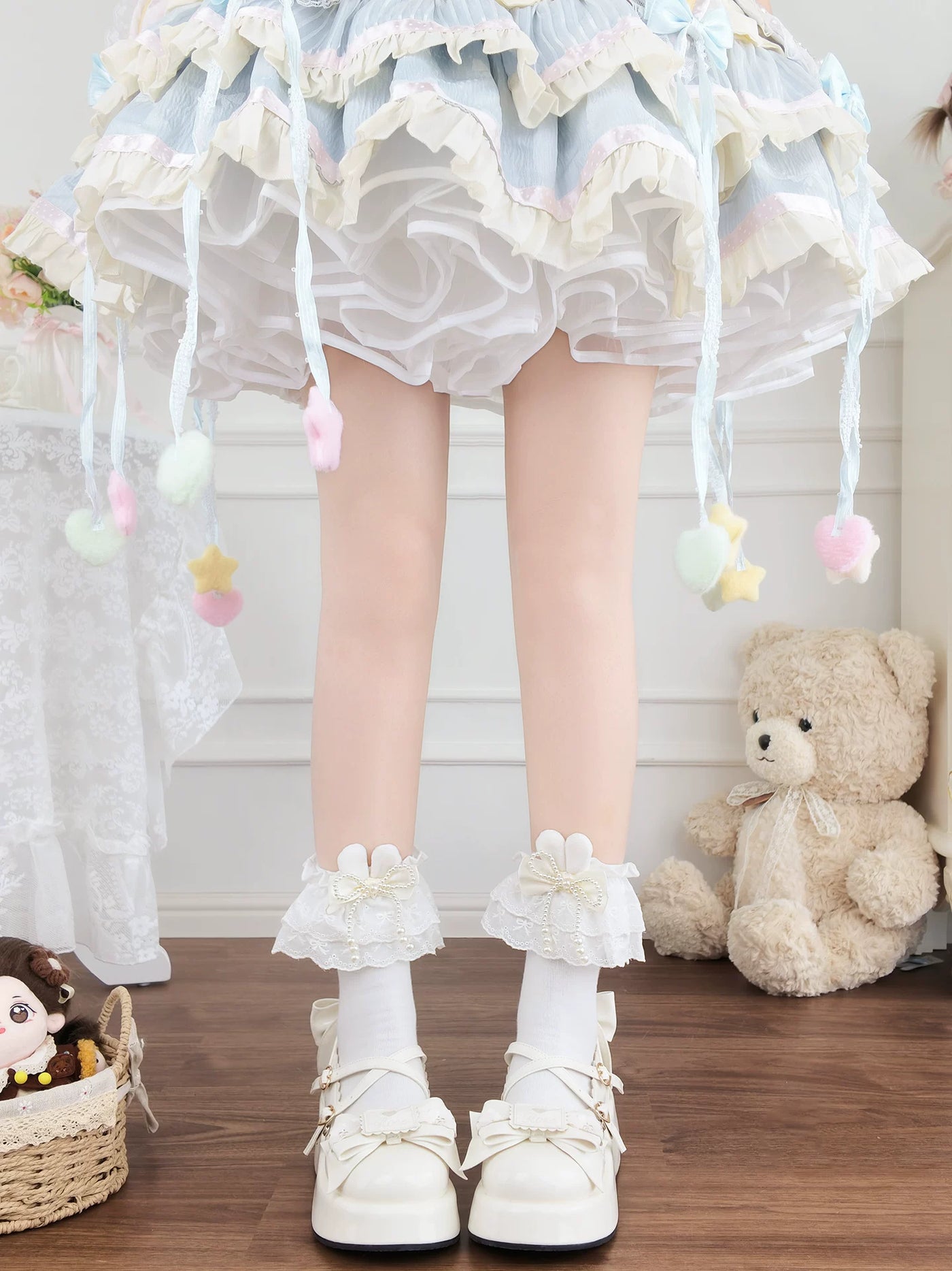 White lace mid-calf socks with bow and pearl details worn with white platform shoes