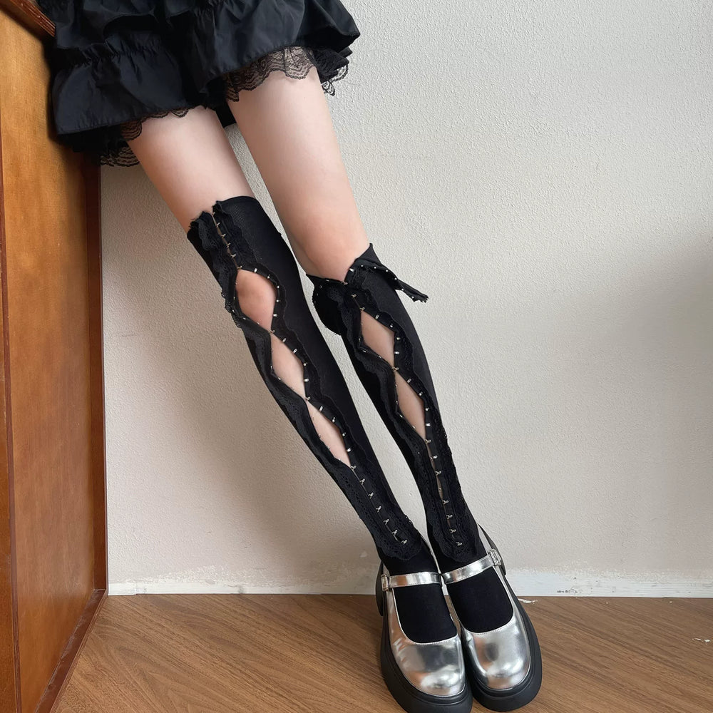 White lace-trimmed openwork over-the-knee socks styled with black platform shoes