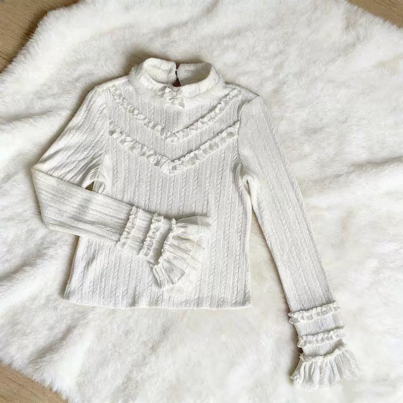 White long-sleeve blouse with high ruffled collar and layered lace cuffs