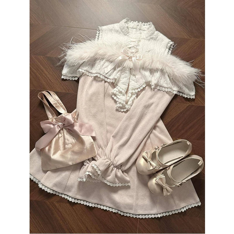 Pale cream Lolita dress arranged flat with lace, bows, and styling accessories