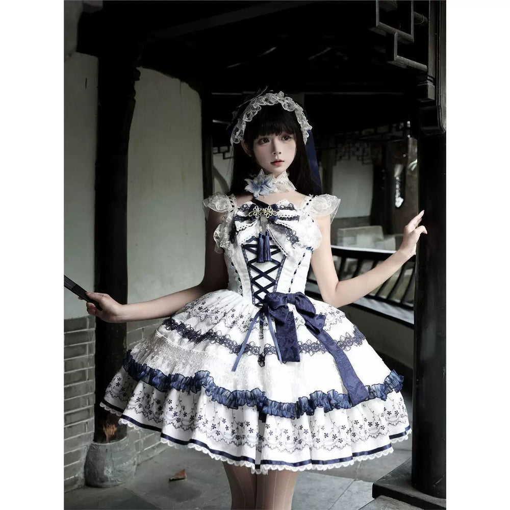 White-and-blue floral JSK with lace ruffles and corset lacing worn by a model outdoors.