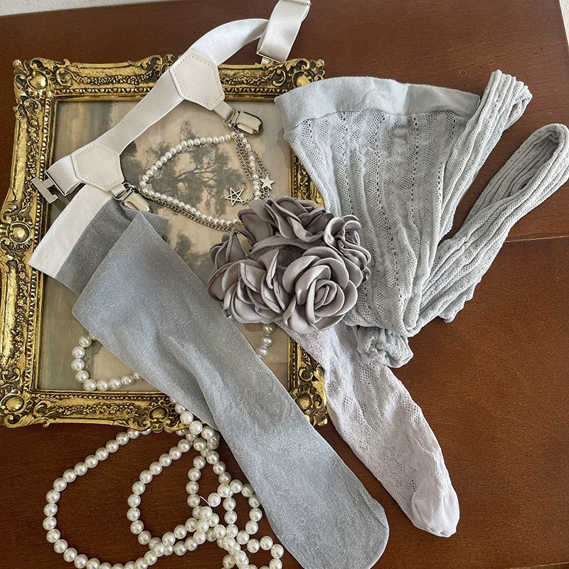 Black and gray layered lace hosiery with camellia details and a thigh leg ring.