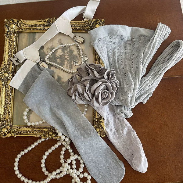 Black and gray layered lace hosiery with camellia details and a thigh leg ring.