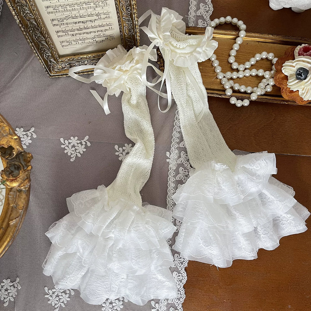 Cream cutout tights and lace stocking covers styled with a layered cream Lolita outfit.