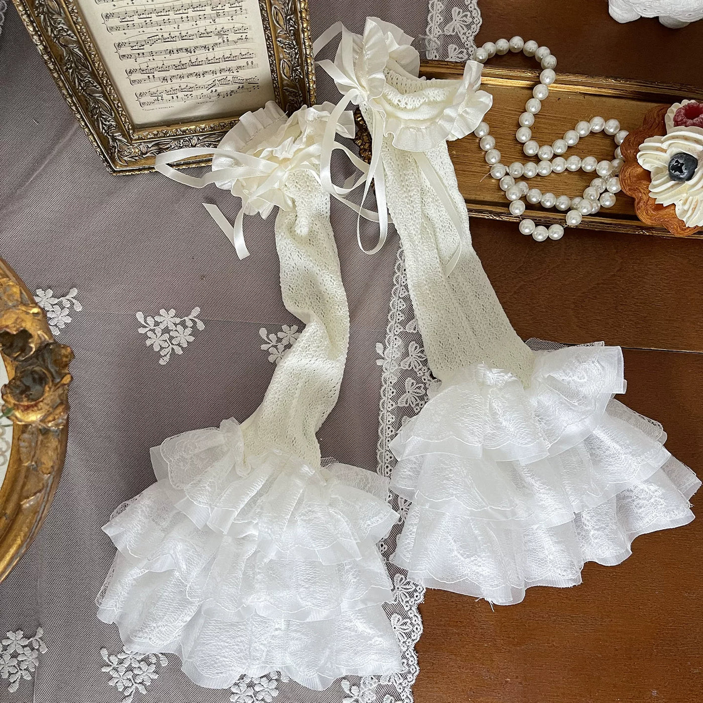 Cream cutout tights and lace stocking covers styled with a layered cream Lolita outfit.