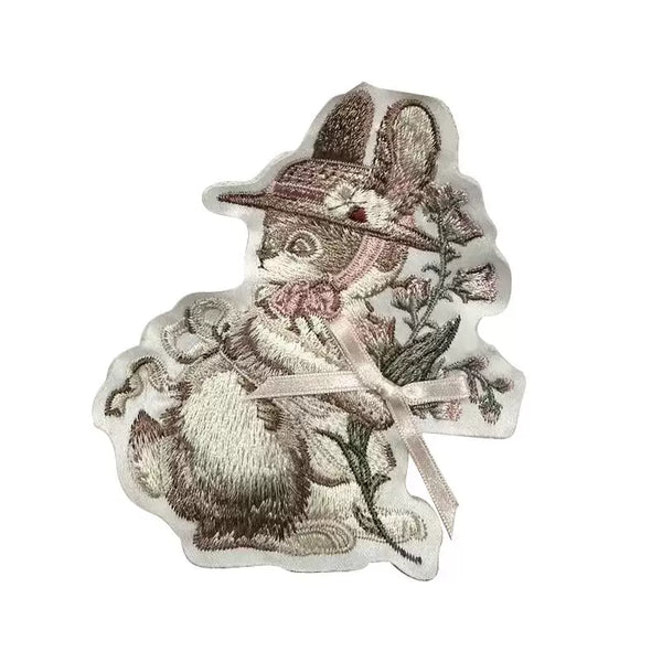 Embroidered rabbit patch beside a cream-and-pink ruffled Lolita coordinate.
