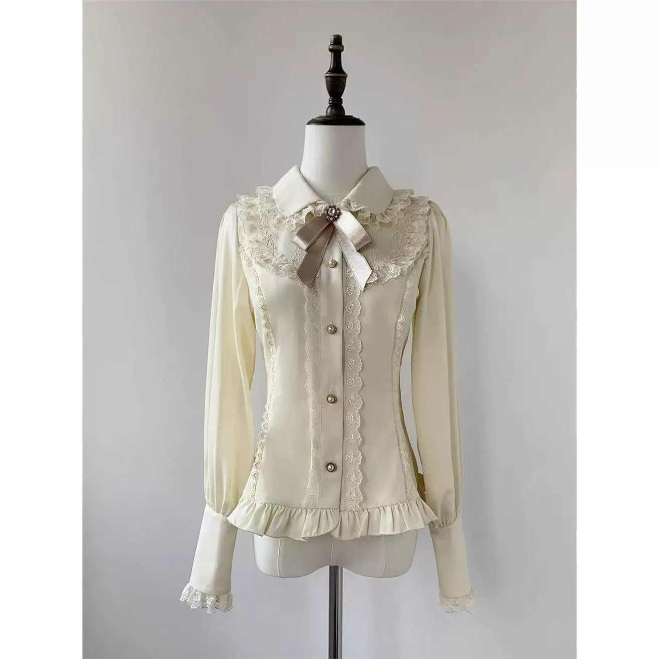 Beige-apricot long-sleeve blouse with lace trim and matching bow