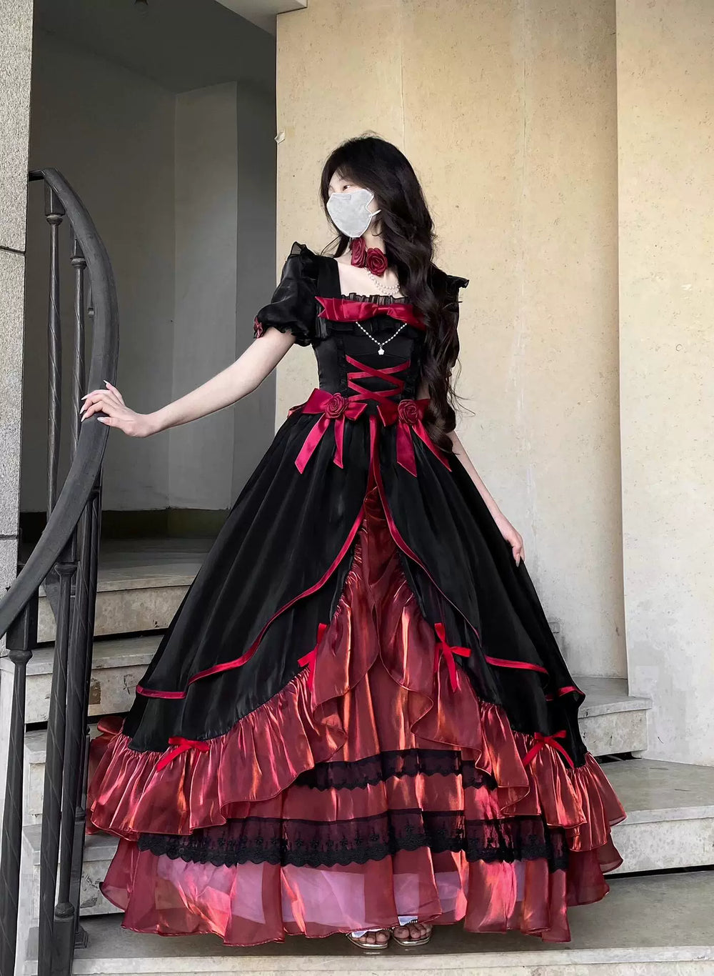 Creamy black-and-red OP dress set with rose accents, layered ruffles and back train.