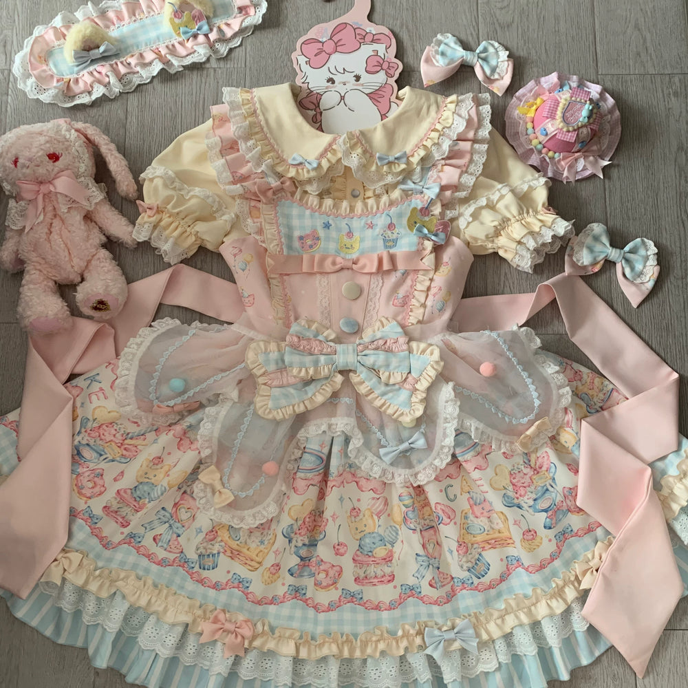 Pastel Sweet Lolita jumper skirt with all-over dessert print, tiered ruffled skirt, and central multi-fabric bow