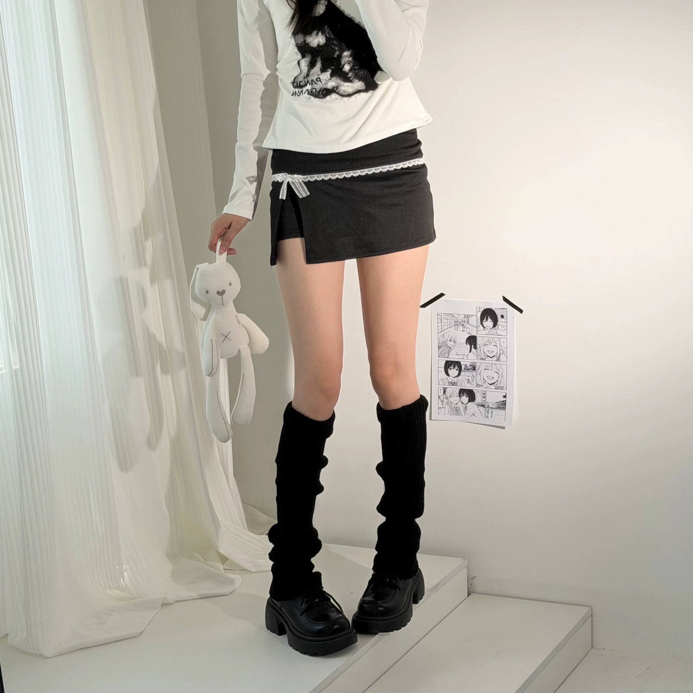 Black and ivory knitted leg warmers in gathered model-worn styling