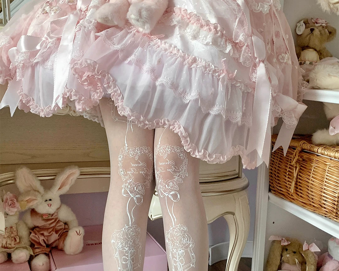 White tights with rose-and-bow frame artwork along the legs.
