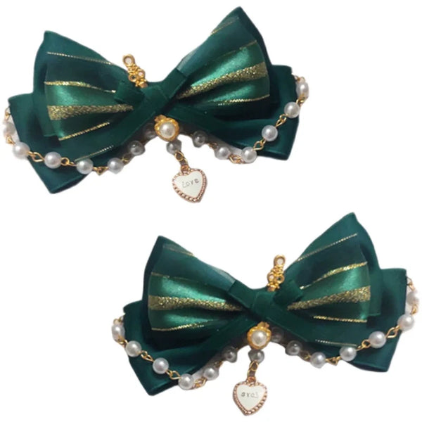 Dark green layered bow hair accessory with pearl chain and heart pendant.