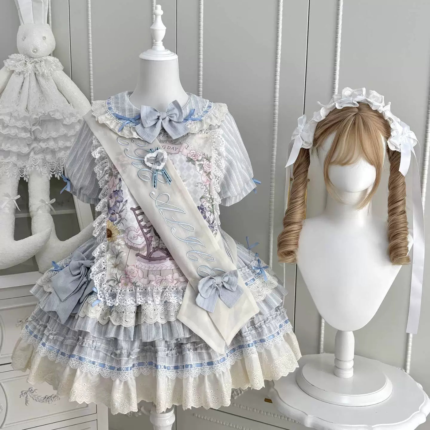 Natural-colour and aqua floral OP dresses with lace ruffles on mannequins