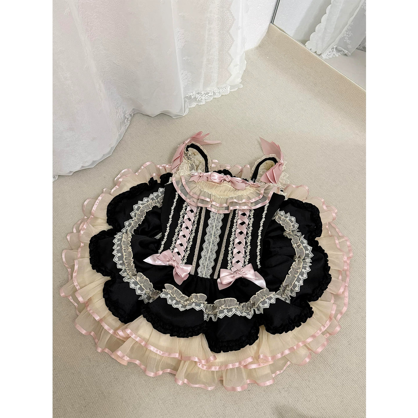 Creamy black and pink ruffle JSK dress with bows shown in a mirror selfie