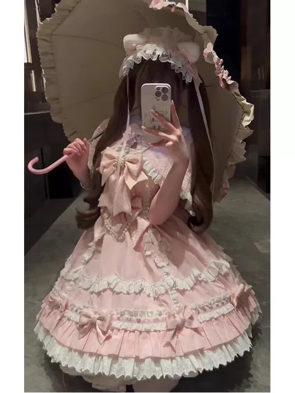 Pink ruffled JSK and matching cape worn by a model in a mirror selfie.