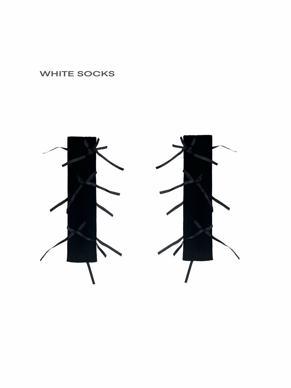 Ribbed socks with black ribbon bows displayed flat on a white background