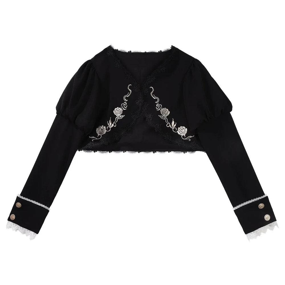 Black embroidered bolero and white long-sleeve blouse with black bow from a Gothic Lolita dress set