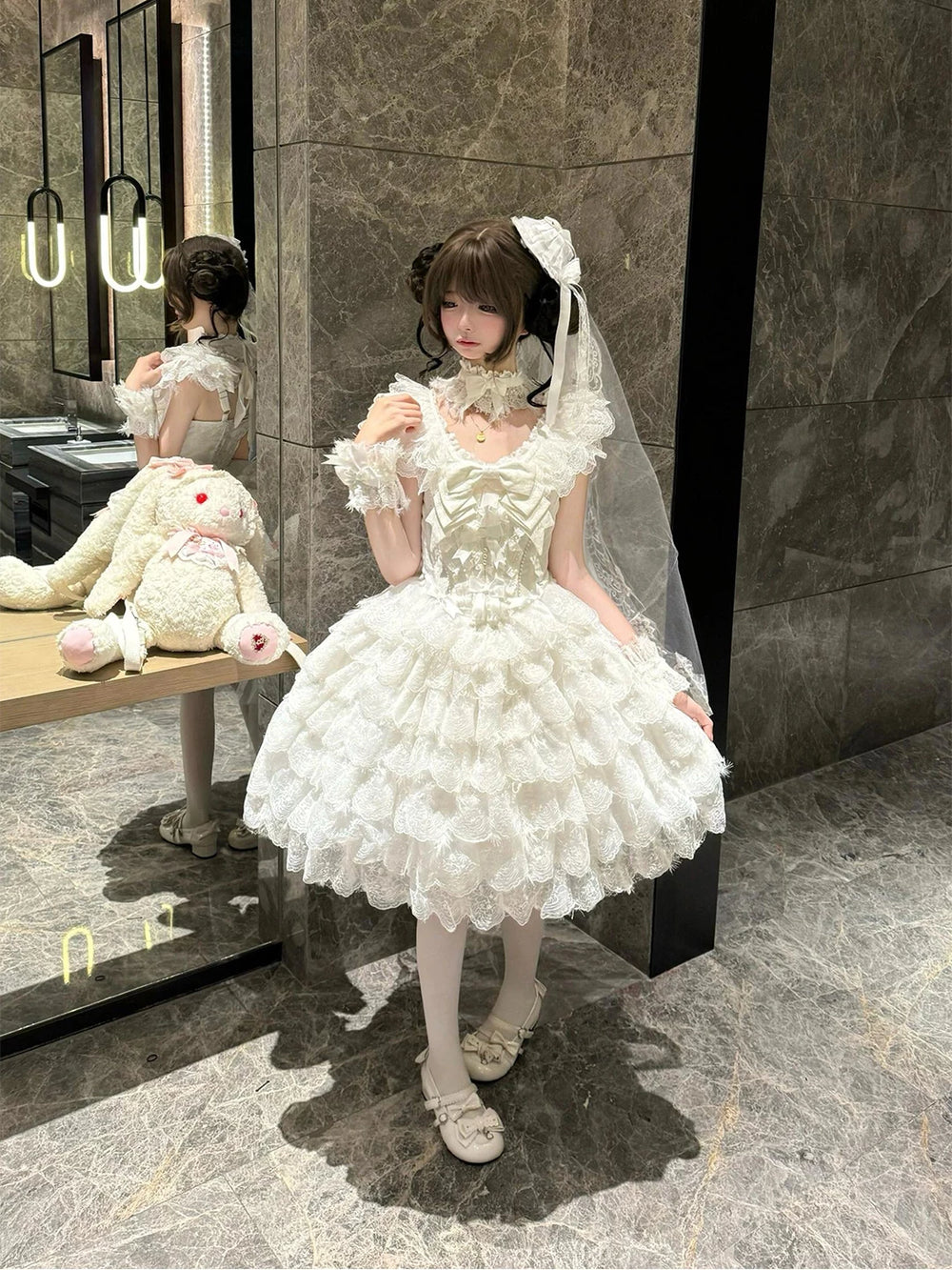 White layered lace JSK dress with shawl and train worn on a model.