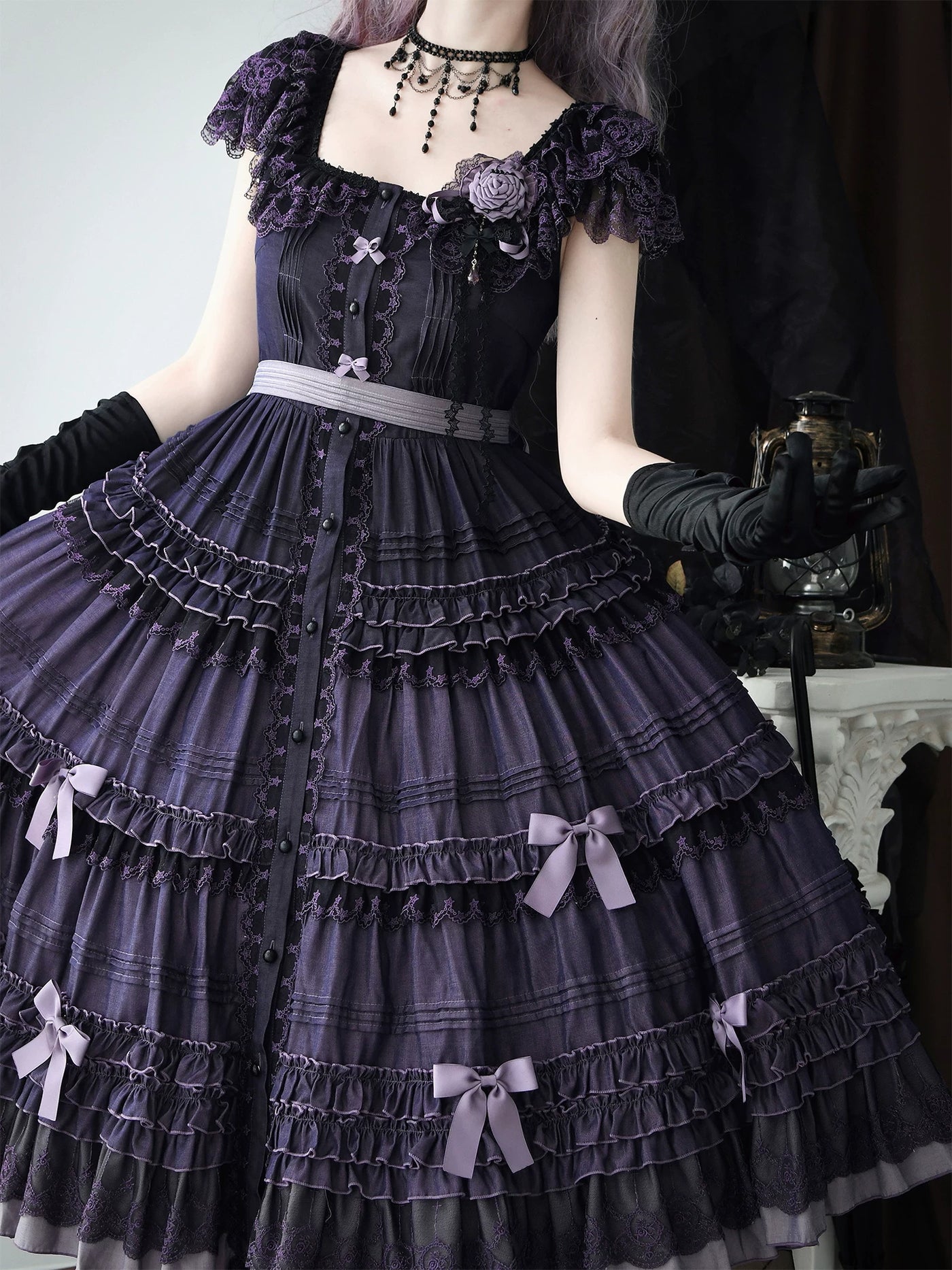 Full view of the JSK's multi-tiered skirt with lace inserts and small bow accents