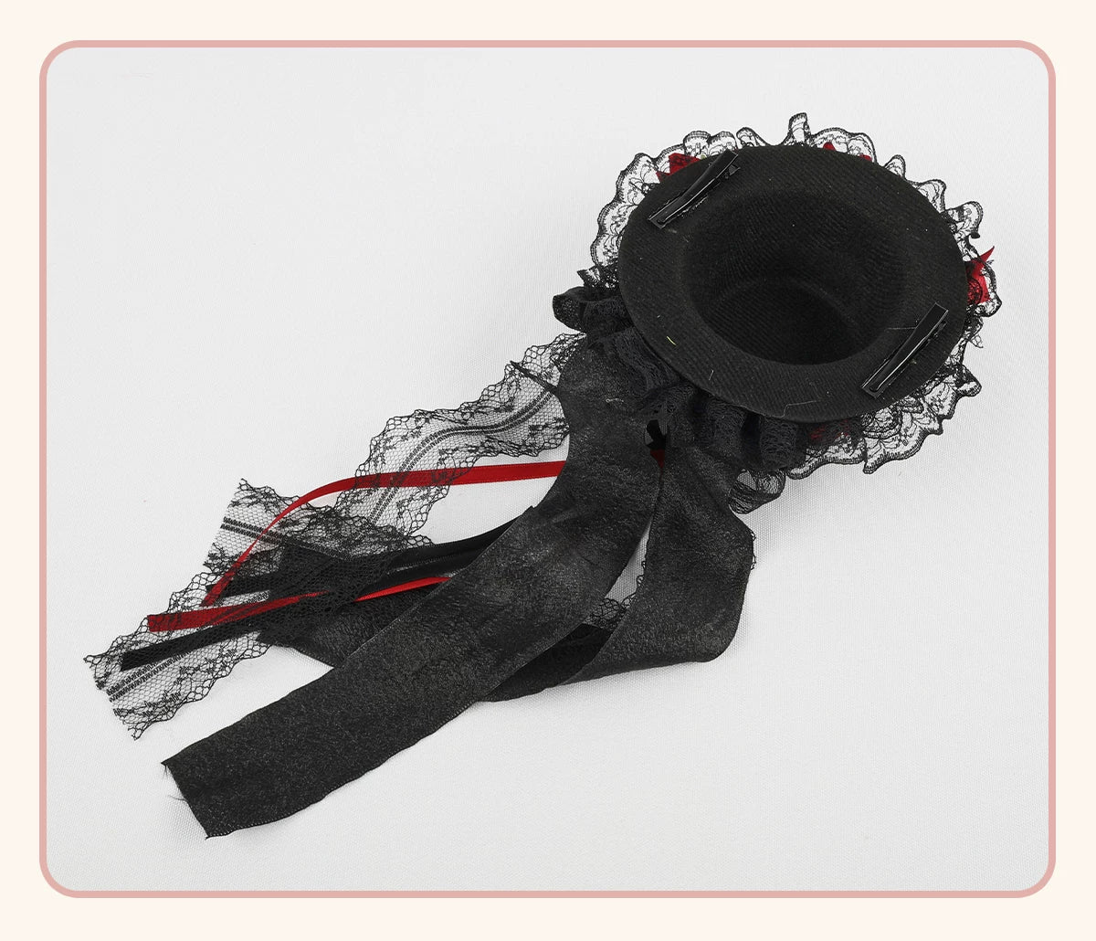 Black mini top hat with lace, red ribbons and black bow detailing.