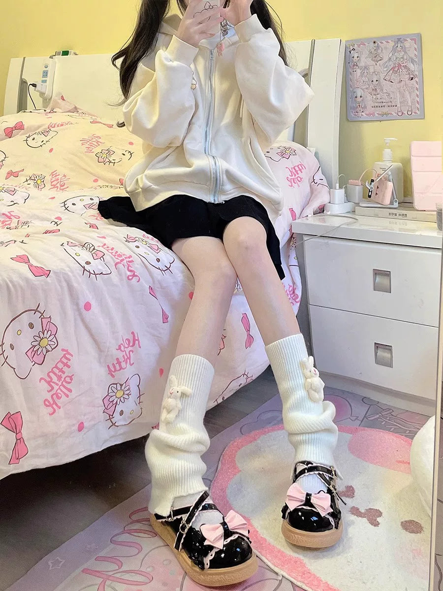 Milky white scrunch socks with small rabbit decorations styled with black Mary Jane shoes.