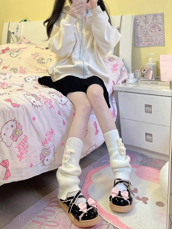 Milky white scrunch socks with small rabbit decorations styled with black Mary Jane shoes.